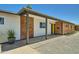 Charming single-story home featuring a brick facade, yellow front door, and desert landscaping at 1930 E Missouri Ave, Phoenix, AZ 85016