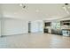 Open-concept living room with sleek floors connecting to a modern kitchen at 1930 E Missouri Ave, Phoenix, AZ 85016