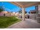 Lush backyard with covered patio, outdoor seating, and ambient string lights at 22259 N 102Nd Ln, Peoria, AZ 85383