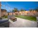 Beautifully landscaped backyard with cozy seating and string lights, perfect for entertaining at 22259 N 102Nd Ln, Peoria, AZ 85383