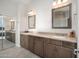 Bathroom features a double sink vanity with framed mirrors and gray cabinets at 22259 N 102Nd Ln, Peoria, AZ 85383