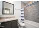 Charming bathroom with stylish gray tile, shower, and vanity at 22259 N 102Nd Ln, Peoria, AZ 85383