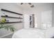 Bedroom with wood shelves, ceiling fan, and doorway at 22259 N 102Nd Ln, Peoria, AZ 85383
