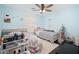 Shared bedroom with two beds, ceiling fan, and a window with shutters at 22259 N 102Nd Ln, Peoria, AZ 85383