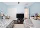 bedroom with blue walls, two beds, and a ceiling fan at 22259 N 102Nd Ln, Peoria, AZ 85383