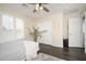 Bedroom features a ceiling fan, windows with shutters, and closet at 22259 N 102Nd Ln, Peoria, AZ 85383