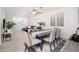 Cozy dining area with natural light, a ceiling fan, and open access to the living room space at 22259 N 102Nd Ln, Peoria, AZ 85383