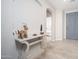 Inviting entryway with light walls, modern flooring, and charming decor on a decorative table at 22259 N 102Nd Ln, Peoria, AZ 85383