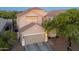 Charming two-story house featuring a neutral color scheme, a tile roof, and a well-maintained front yard at 22259 N 102Nd Ln, Peoria, AZ 85383