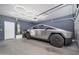 Finished garage featuring a contemporary vehicle, modern lighting and neutral walls at 22259 N 102Nd Ln, Peoria, AZ 85383