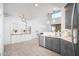 Bright, neutral kitchen featuring two-tone cabinets, stainless appliances, and stylish pendant lighting at 22259 N 102Nd Ln, Peoria, AZ 85383