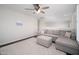 Second floor living room features a comfy sectional sofa with ottoman and a ceiling fan at 22259 N 102Nd Ln, Peoria, AZ 85383