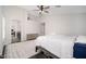 Main bedroom with a ceiling fan, a rustic wood bed, and an ensuite bathroom at 22259 N 102Nd Ln, Peoria, AZ 85383