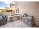 Modern outdoor kitchen with stone counters and stainless steel grill at 22259 N 102Nd Ln, Peoria, AZ 85383