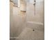 Tiled walk-in shower with built-in bench, niche, and shower head at 22259 N 102Nd Ln, Peoria, AZ 85383