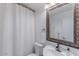 Cozy bathroom featuring a ornate mirror, white sink, and tiled shower at 2326 E Evans Dr, Phoenix, AZ 85022