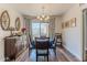 An elegant dining room featuring wood floors, a chandelier, and a table set for six guests at 2326 E Evans Dr, Phoenix, AZ 85022
