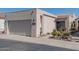 Charming home exterior with a two-car garage and desert landscaping with succulents and flower pots at 2326 E Evans Dr, Phoenix, AZ 85022