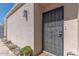 Inviting front entry with decorative security door, desert landscaping, and exterior lighting at 2326 E Evans Dr, Phoenix, AZ 85022