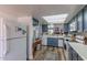 Bright kitchen with modern appliances, a skylight, white countertops, and ample cabinet space at 2326 E Evans Dr, Phoenix, AZ 85022