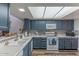 Well-lit kitchen with modern appliances, mosaic tile backsplash and ample counter space at 2326 E Evans Dr, Phoenix, AZ 85022