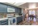 Updated kitchen with modern appliances, mosaic backsplash, and eat-in dining area at 2326 E Evans Dr, Phoenix, AZ 85022