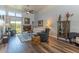 Open living room with fireplace, hardwood floors, clerestory windows, and a ceiling fan at 2326 E Evans Dr, Phoenix, AZ 85022