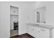 Bright bathroom featuring modern vanity with marble countertop and stylish fixtures, next to a walk-in closet at 24138 S 220Th St, Queen Creek, AZ 85142