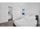 Bright bedroom showcases a window with an exterior view; a bathroom is attached to the room at 24138 S 220Th St, Queen Creek, AZ 85142