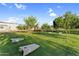 Community green space featuring cornhole boards, lush trees, and meticulously maintained landscaping at 24138 S 220Th St, Queen Creek, AZ 85142