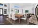 Well-lit dining area with modern furniture and seamless indoor-outdoor living at 24138 S 220Th St, Queen Creek, AZ 85142