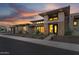 Stunning two-story home with stone accents and a well-manicured front yard at dusk at 24138 S 220Th St, Queen Creek, AZ 85142