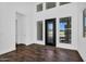 This home foyer boasts an ornate front door and is surrounded by large windows at 24138 S 220Th St, Queen Creek, AZ 85142
