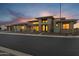 Beautiful home with large windows and lush desert landscaping at dusk at 24138 S 220Th St, Queen Creek, AZ 85142