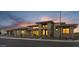 Exterior view of a desert home at dusk with elegant stone accents and warm lighting at 24138 S 220Th St, Queen Creek, AZ 85142