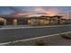 Exterior view of desert home with elegant stone accents at sunset at 24138 S 220Th St, Queen Creek, AZ 85142