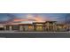 Stunning single-Gathering home boasting a spacious three-car garage against a backdrop of a vibrant sunset at 24138 S 220Th St, Queen Creek, AZ 85142