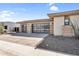 Attractive three-car garage with modern glass doors complemented by desert-style landscaping at 24138 S 220Th St, Queen Creek, AZ 85142