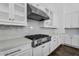 Modern kitchen features white cabinets, stainless steel appliances, and light countertops at 24138 S 220Th St, Queen Creek, AZ 85142