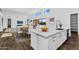 Bright kitchen with white cabinets and a quartz countertop island overlooking living area at 24138 S 220Th St, Queen Creek, AZ 85142