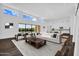 Bright, open living room with hardwood floors and high transom windows at 24138 S 220Th St, Queen Creek, AZ 85142