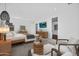 Spacious main bedroom with neutral tones, bench seating, a TV, and seating area at 24138 S 220Th St, Queen Creek, AZ 85142