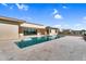 Backyard featuring a sparkling pool, stone pavers, and lush landscaping at 24138 S 220Th St, Queen Creek, AZ 85142