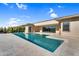 Inviting backyard pool with spacious travertine tile and manicured landscaping at 24138 S 220Th St, Queen Creek, AZ 85142