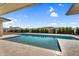 This luxury pool is surrounded by stone pavers and lush landscaping at 24138 S 220Th St, Queen Creek, AZ 85142