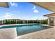This sparkling pool is surrounded by stone pavers and lush landscaping at 24138 S 220Th St, Queen Creek, AZ 85142