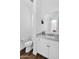 Neutral powder room features tile floors, updated plumbing fixtures, and a custom mirror at 24138 S 220Th St, Queen Creek, AZ 85142