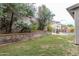 Expansive backyard with mature trees, beautiful flowers, and a pool view at 2709 E Vista Dr, Phoenix, AZ 85032