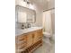 Bathroom with patterned tile flooring and a wood vanity with marble countertop at 2709 E Vista Dr, Phoenix, AZ 85032