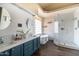 Bright bathroom featuring dual sinks, soaking tub, and a walk-in shower at 2709 E Vista Dr, Phoenix, AZ 85032